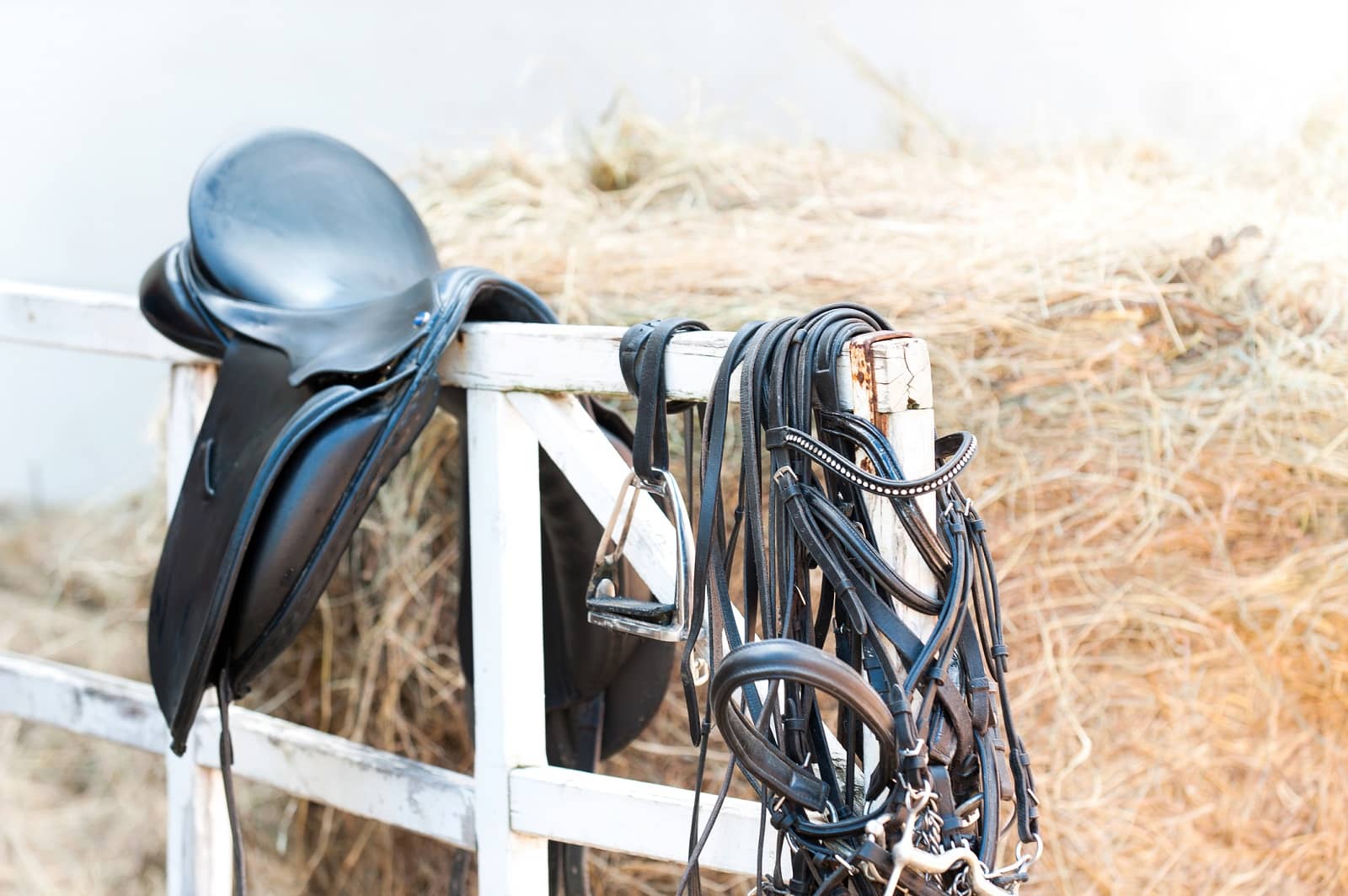 Saddle drapped on fence