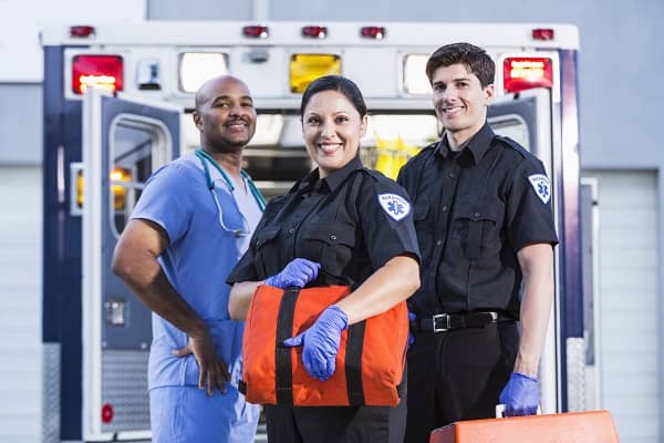 Paramedics and doctor outside ambulance
